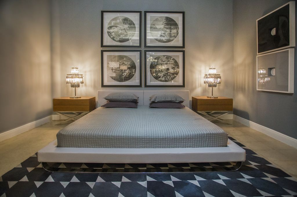 Neutral bedroom with wall art and bedside glass lamps