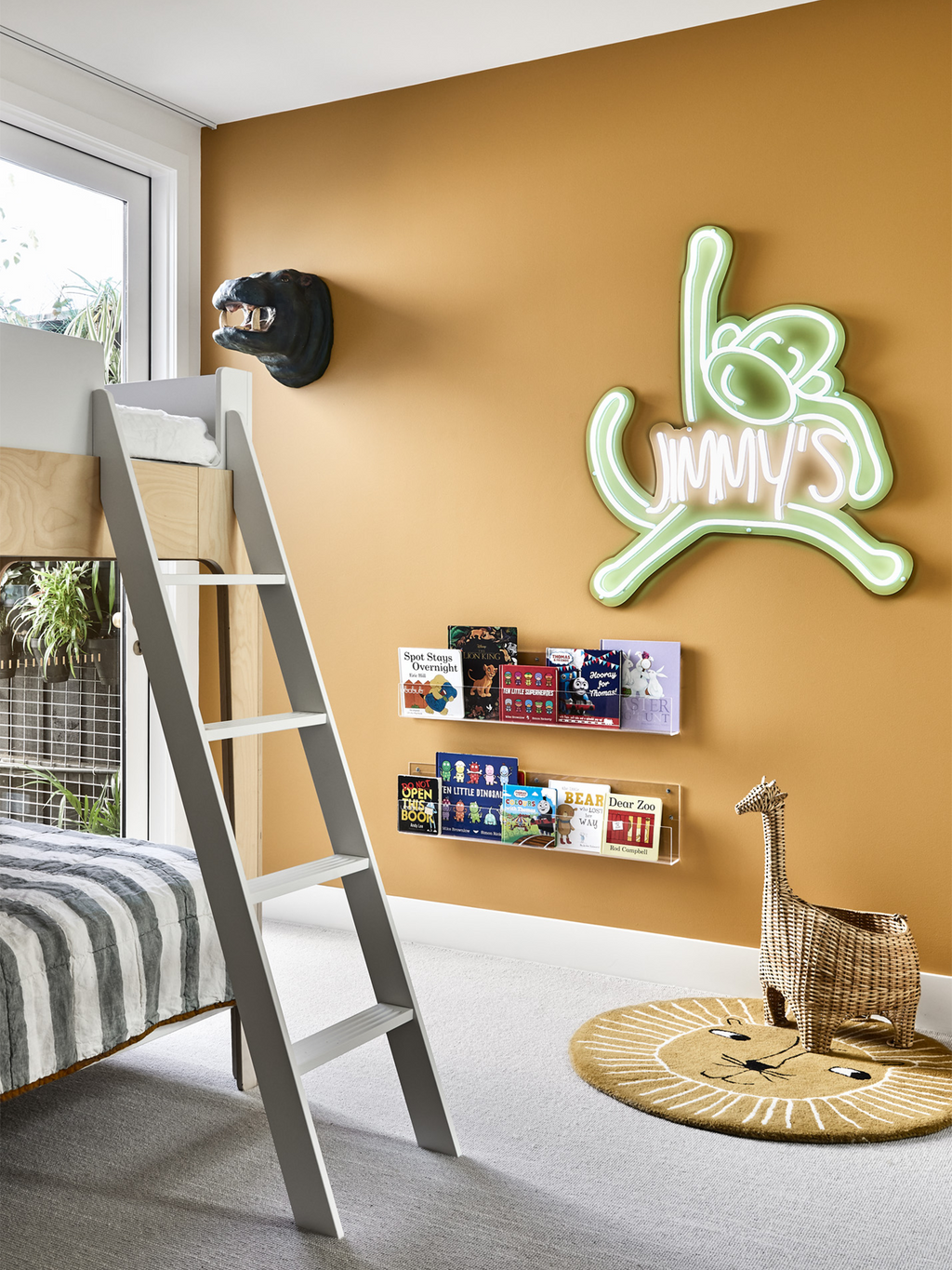 Kids bedroom with orange statement wall and green neon sign