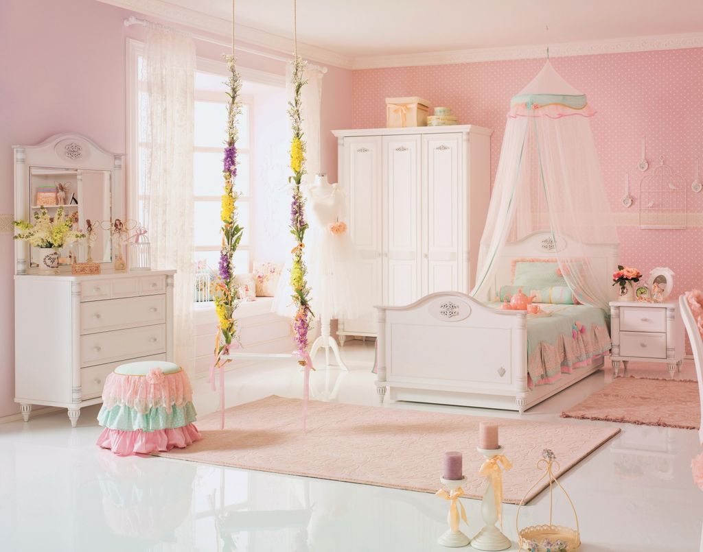 Girls bedroom with pink wallpaper and princess canopy bed