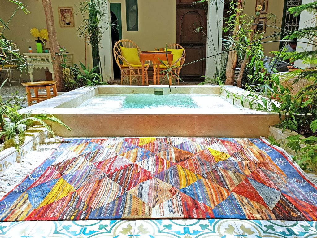 Outdoor hot tub with colourful rug