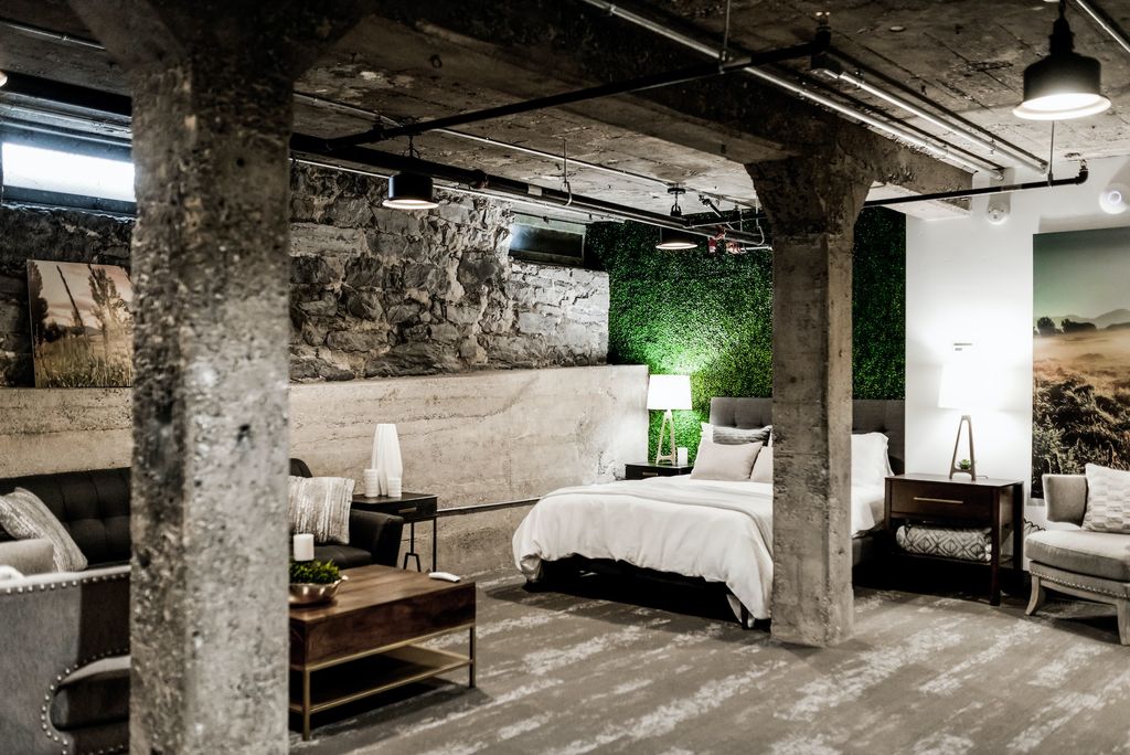 Industrial inspired bedroom with exposed stone pillars and raw materials 