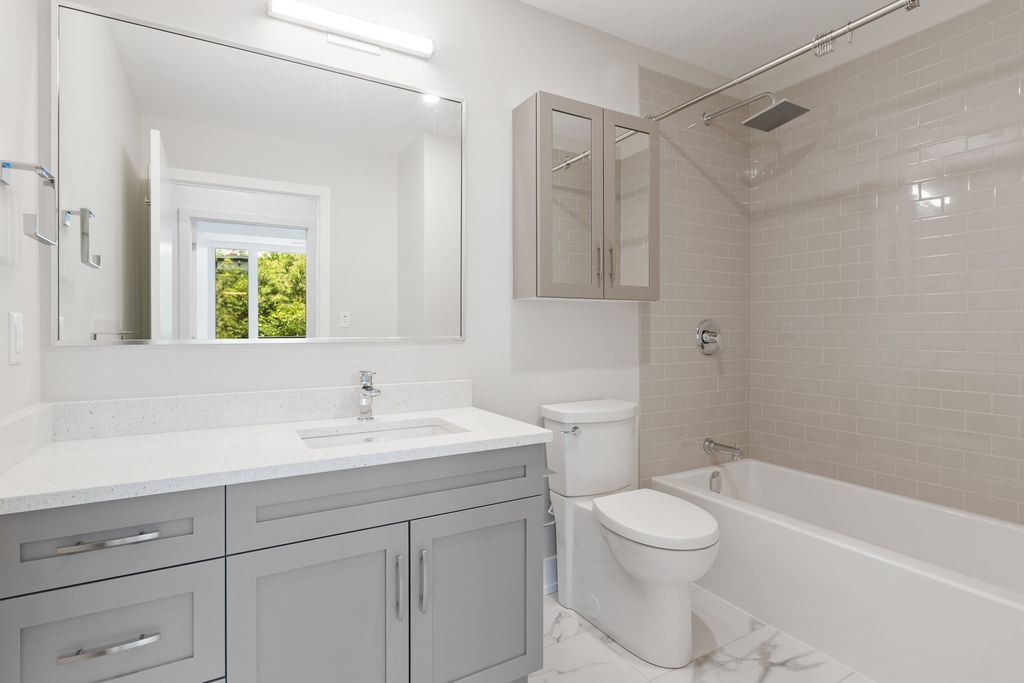 Bathroom with light grey vanity and medicine cabinet