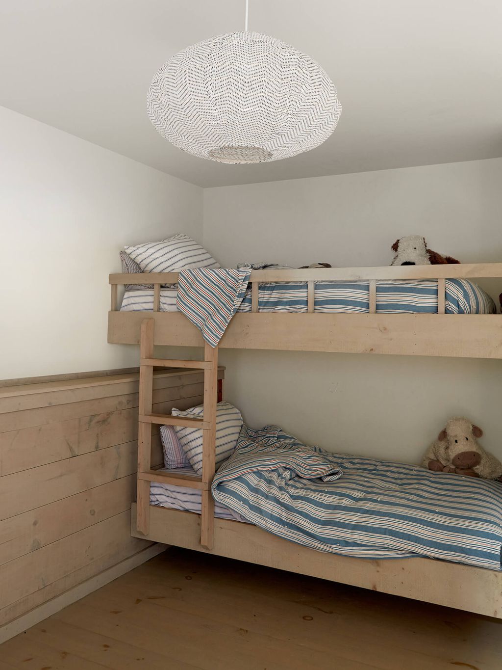 Simple kids room with wooden tones and bunk beds