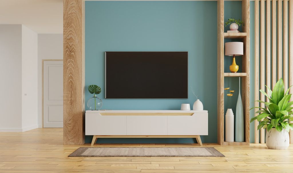 Media console with tv and light blue accent color wall