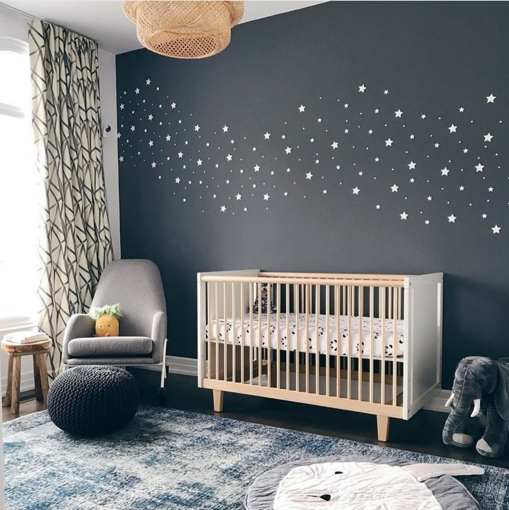Nursery with glow in the dark stars painted on dark grey wall