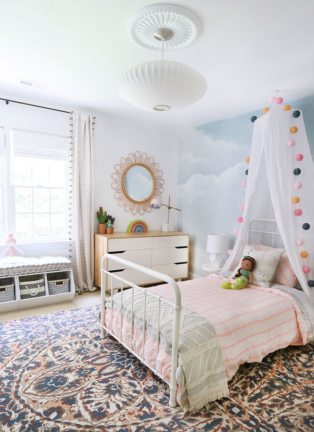 Girl bedroom with light pale colours and canopy bed