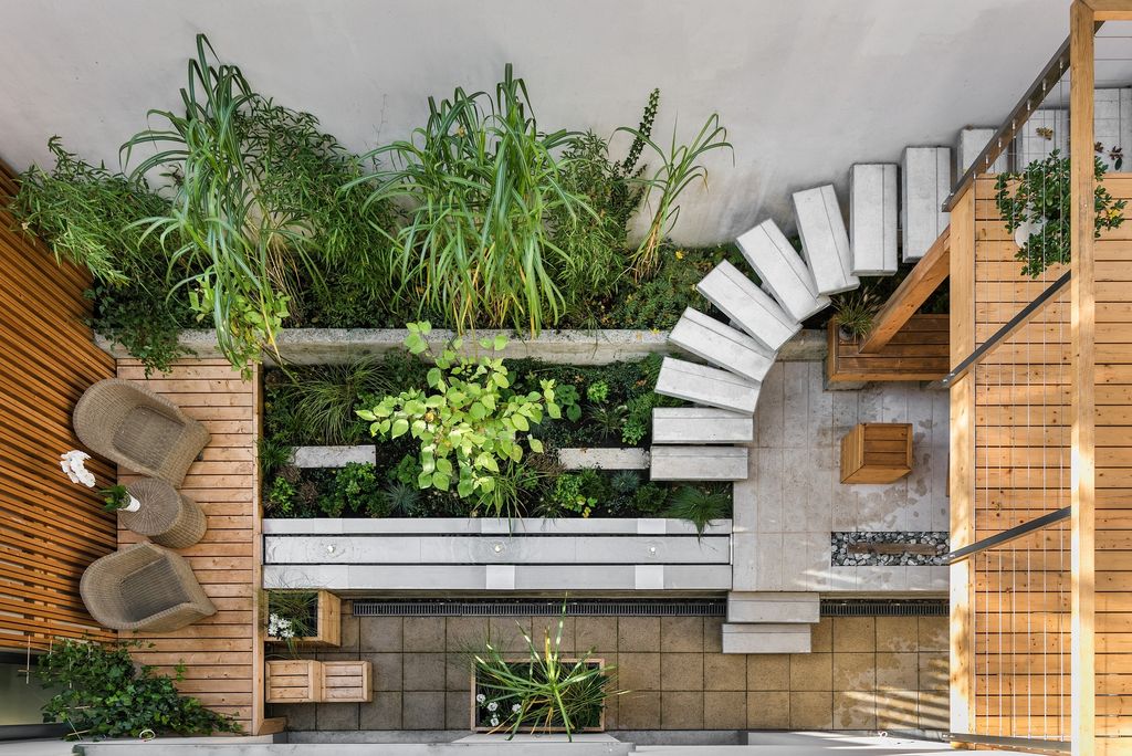 Outdoor terrace with potted plants and light wood flooring 