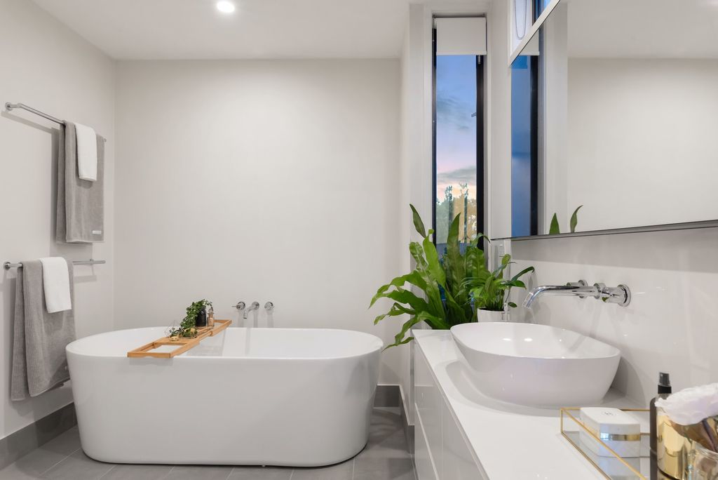 White bathroom with tub and vessel sink