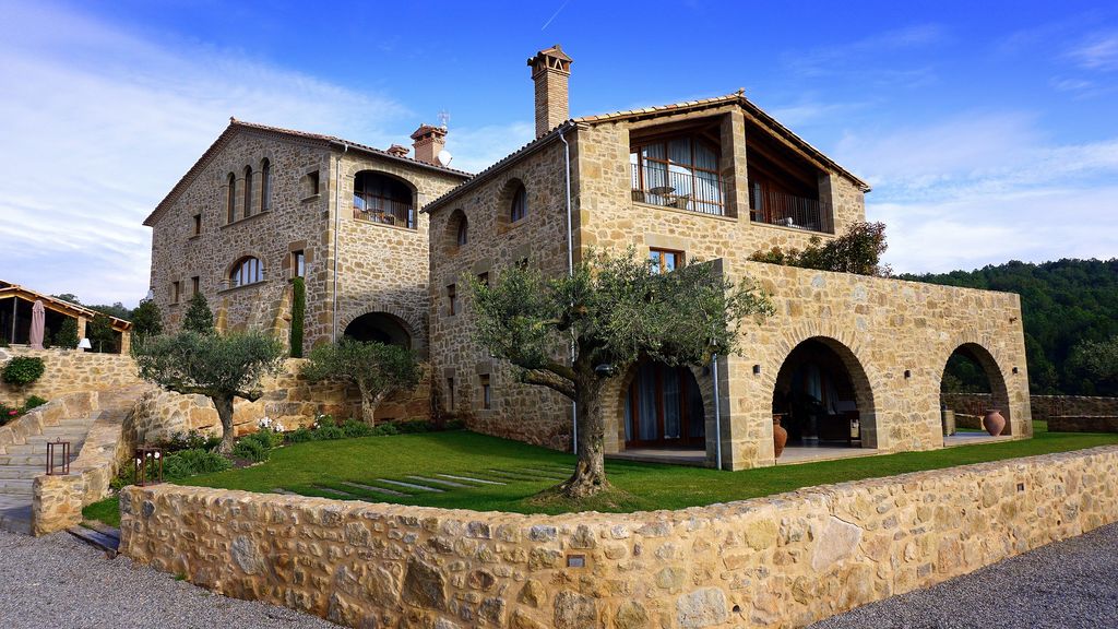 Rustic stone house with landscape trees