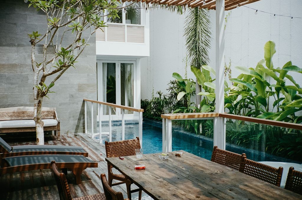 Terrace with pool and wooden furniture
