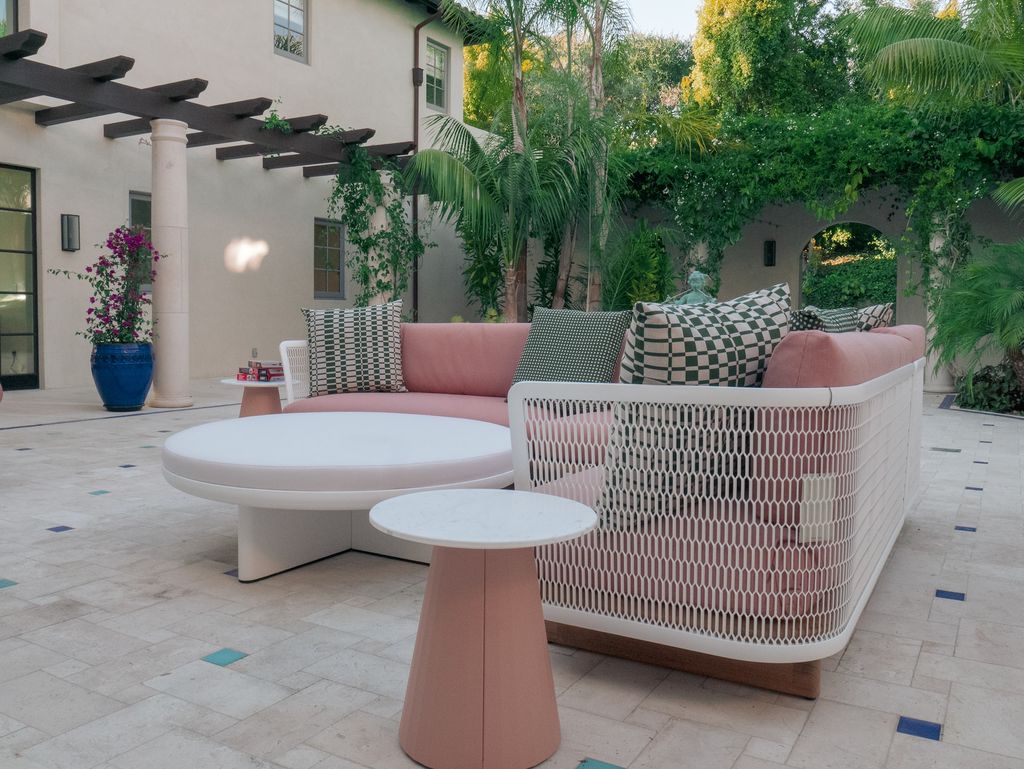 Terrace with modern pastel colour furniture and big potted plants