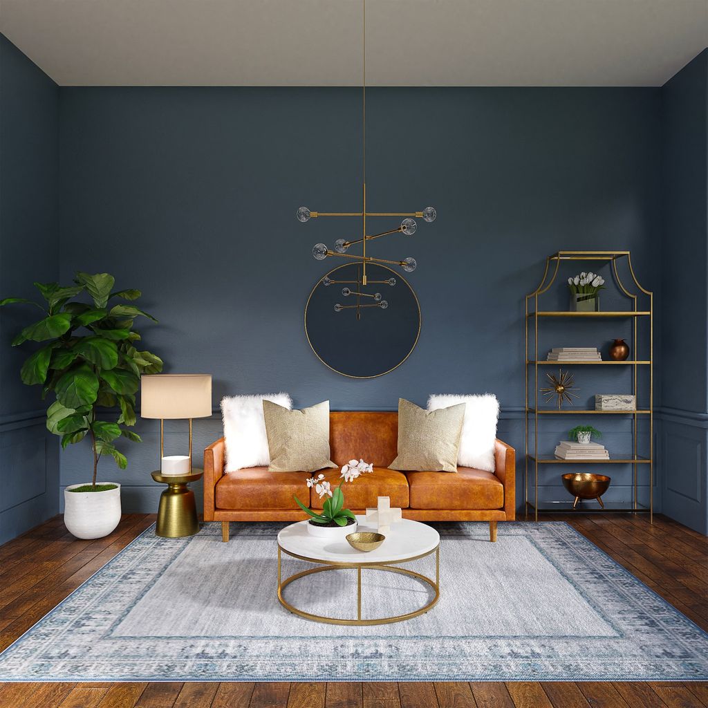 Living room with brown leather couch, rug and dark blue walls